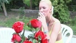 Shaved blonde smokes cigarette and fucks outdoors